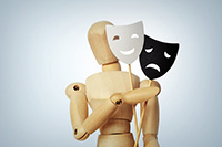 Wooden mannequin with two masks showing different emotions - CalypsoArt/Shutterstock.com